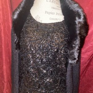 A sweater with a fur collar